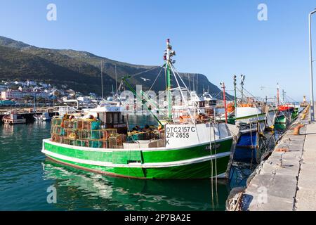 Fishing boats moored in Kalk Bay Harbour, Cape Town, Western Cape, South Africa at sunset, A popular tourist attraction and fish market Stock Photo