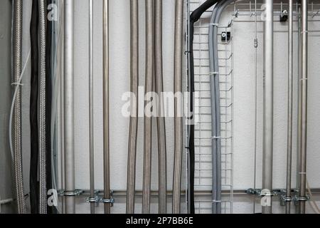 https://l450v.alamy.com/450v/2p7bb6e/industrial-wall-mounted-vertical-running-stainless-aluminum-pipes-2p7bb6e.jpg