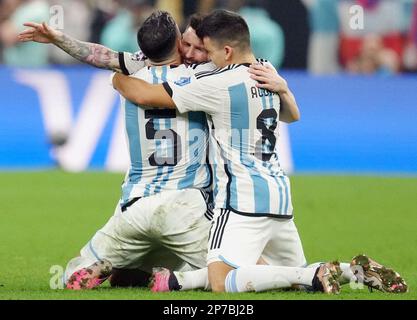 Argentina's Lionel Messi falls to his knees in celebration with teammates Leandro Paredes (left) Marcos Acuna (right) after Argentina's Gonzalo Montiel scores the winning penalty in the shoot out during the FIFA World Cup final at Lusail Stadium, Qatar. Picture date: Sunday December 18, 2022. Stock Photo