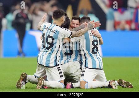 Argentina's Lionel Messi falls to his knees in celebration with teammates Nicolas Otamendi (19), Leandro Paredes (5) and Marcos Acuna (right) after Argentina's Gonzalo Montiel scores the winning penalty in the shoot out during the FIFA World Cup final at Lusail Stadium, Qatar. Picture date: Sunday December 18, 2022. Stock Photo