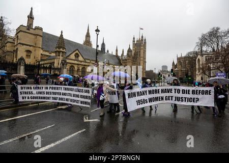 London, UK.  8 March 2023. Participants block the road outside the Houses of Parliament during a Women Against State Pension Inequality (WASPI) protest in Parliament Square on International Women’s Day.  The group continues to campaign for women born in the 1950s who are facing financial hardship following after the 1995 State Pension Act raised the women’s state pension age from age 60 to 65.  Credit: Stephen Chung / Alamy Live News Stock Photo