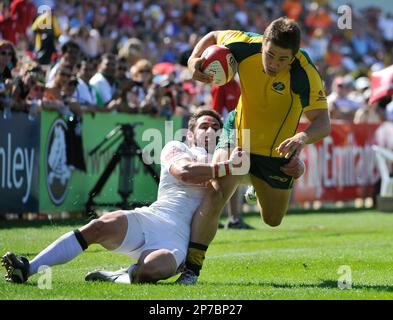 England's Ben Gollings tackles Gregory Jeloudev of Australia, during their Dubai Sevens rugby match, in Dubai, UAE, Saturday Dec. 4, 2010, the first leg of the Sevens World Series Cup. (AP Photo/Stephen Hindley)