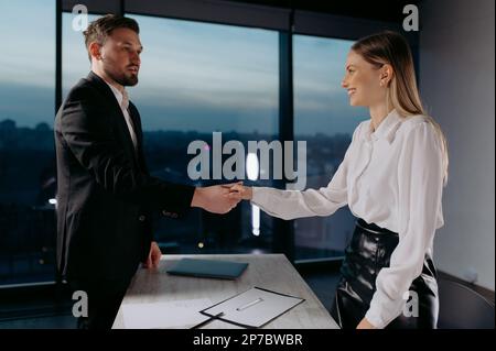 Businesspeople handshaking after negotiation or interview at office Stock Photo