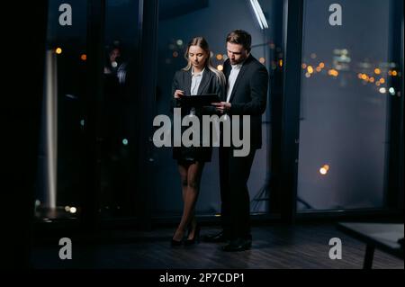two businessmen looking at documents together in the office. late work in the office. Stock Photo