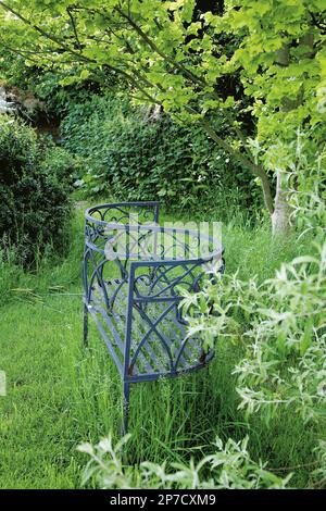 S-shaped love seat in quiet area of cottage garden
