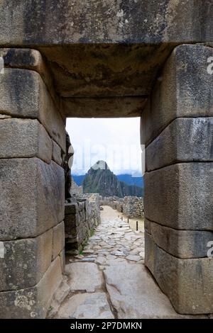 Machu Picchu, Gate in the ruined city of the Incas with the Mount Huayana Picchu, Andes Cordilleria, Urubamba province, Cusco, Peru Stock Photo