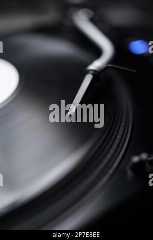 Retro DJ turn table plays vinyl record with music. Turntables needle on tone arm Stock Photo