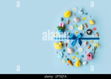Collection of Easter objects laid out in an Easter egg shape, overhead view, flat lay Stock Photo