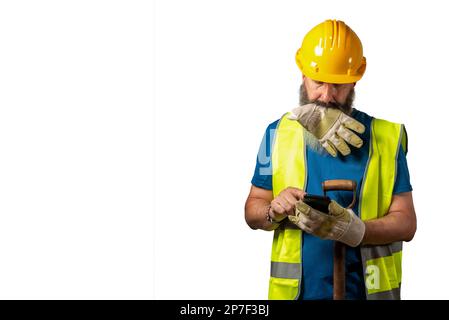 Construction worker consulting the mobile at work. White background with space for text. Stock Photo