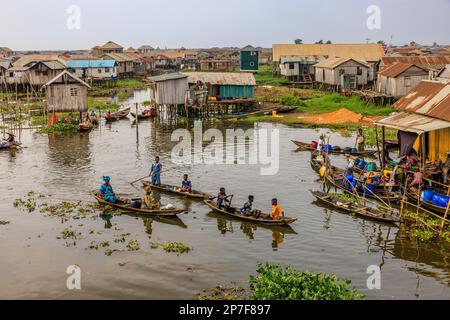 aerial view of traditional wooden boats paddling to the floating market at ganvie on lake nokwie benin Stock Photo