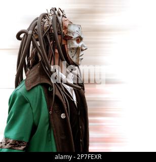 A cyberpunk with cables and wires protruding from his head. Stock Photo