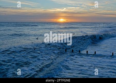 A winter sunset over an empty sea and horizon at Worthing West Sussex, England UK Stock Photo