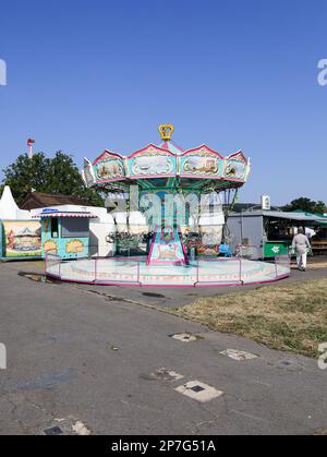 colorful booths and fun rides at a fairground Stock Photo - Alamy