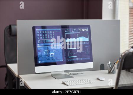 Clean background image of computer screen with scientific data analysis at empty workplace desk in office Stock Photo