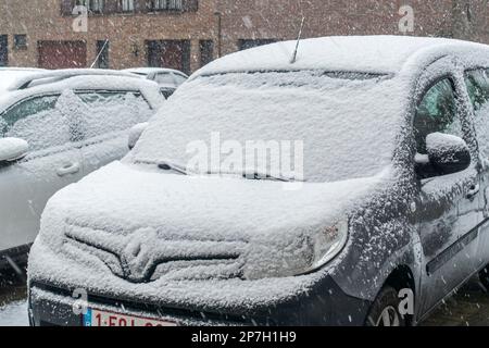 Parked cars covered in snow during unexpected late snow shower in March 2023, Mariakerke, Ghent, East Flanders, Belgium Stock Photo