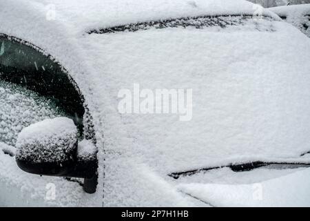 Parked car covered in snow during unexpected late snow shower in March 2023, Mariakerke, Ghent, East Flanders, Belgium Stock Photo