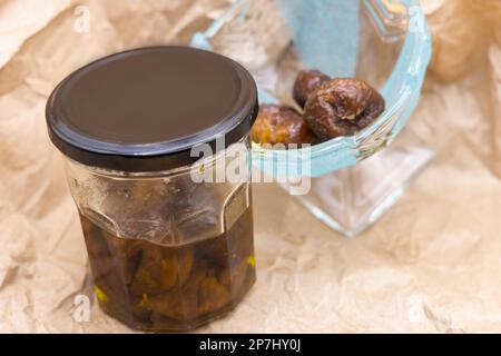 Figs Soaked in Olive Oil - High Health Benefits  -Fig plant is one of the fruits mentioned in the Quran, along with olives - Islamic Medicine Stock Photo