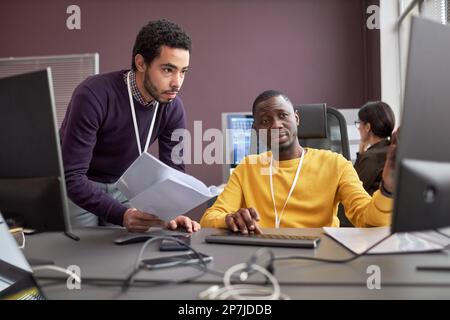 Portrait of two business people discussing project in IT development company Stock Photo