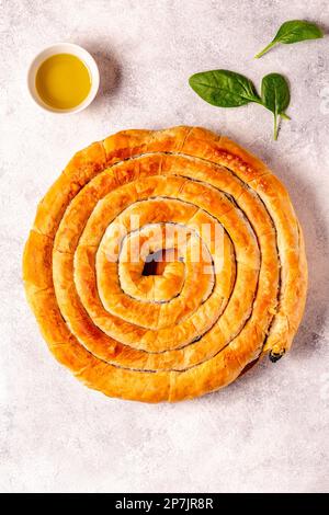 Spanakopita, greek phyllo pastry pie with spinach and feta cheese filling. Top view. Stock Photo