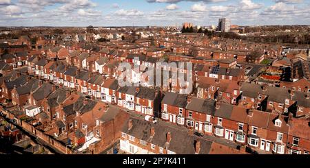 An aerial panorama view of rows of red brick back to back terraced housing in a run down Northern city in England Stock Photo