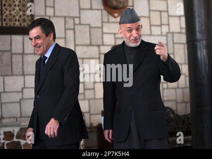 Afghan President Hamid Karzai, right, gestures as he and the French Prime Minister Francois Fillon arrive for a news conference in Kabul, Thursday Feb. 11, 2010. (AP Photo/Ahmad Masood, Pool)