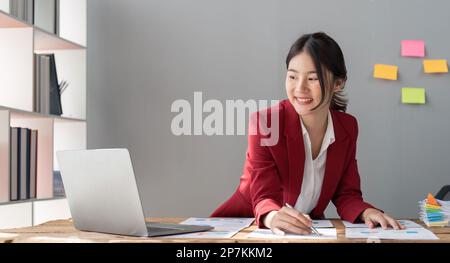 Female businesswoman accountant or financial expert analyze business report graph and finance chart at corporate office Stock Photo