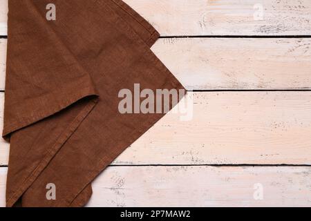 Folded napkin on light wooden background Stock Photo