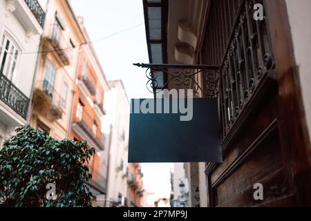 Mock up of restaurant black signboard on yellow wall Stock Photo