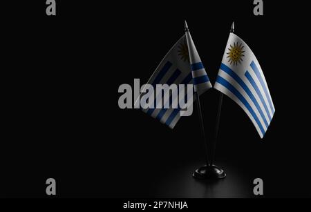 Small national flags of the Uruguay on a black background. Stock Photo