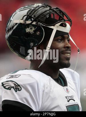 Philadelphia Eagles quarterback Michael Vick's daughter Jada Vick, 6, left,  tries to take her father's helmet off her sister London Vick, 3, after an  NFL football training camp practice at Lehigh University