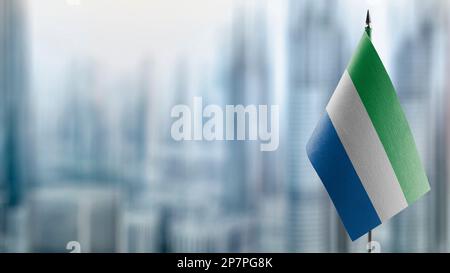 Small flags of the Sierra Leone on an abstract blurry background Stock ...