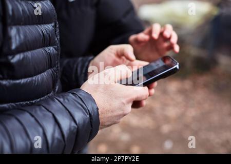 Male hands using mobile phone Stock Photo
