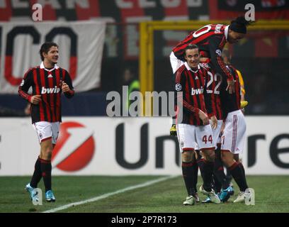 AC Milan forward Marco Borriello covered by teammates celebrates