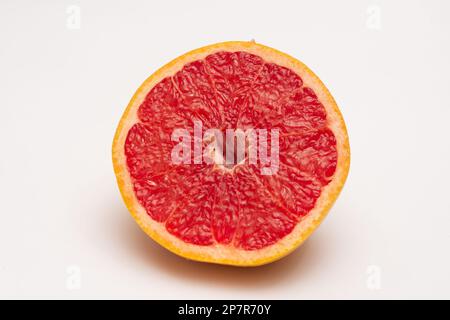 Sliced side of a grapefruit with red pulp isolated on a white background Stock Photo