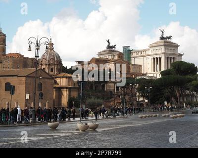 Via dei fori imperiali in the historic city center of Rome, Italy, with many tourists walking on the sidewalk. Stock Photo