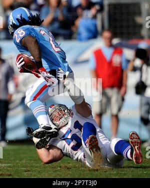 Buffalo Bills linebacker Paul Posluszny (51) hangs on to Tennessee Titans  running back Chris Johnson (28) to bring him down during the second quarter  of an NFL football game in Nashville, Tenn.,