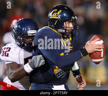 California quarterback Kevin Riley, center, is tackled by Arizona's Earl  Mitchell (49) and Brooks Reed (42) during the first half of an NCAA college  football game Saturday, Nov. 14, 2009, in Berkeley