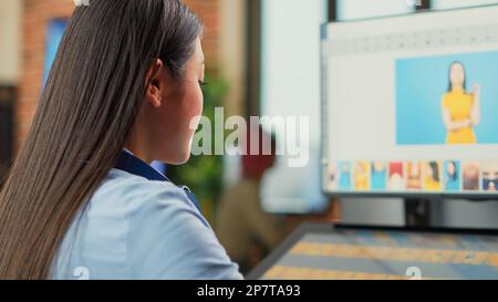 Woman freelancer using retouching software on computer, working on professional multimedia design in agency studio. Female editor developing new color grading images with interface. Close up. Stock Photo