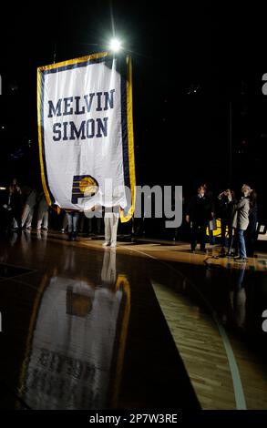 Members of the Simon family lift a banner in honor of the late Indiana  Pacers co-owner Mel Simon before an NBA basketball game in Indianapolis,  Friday, Nov. 6, 2009. The banner bears