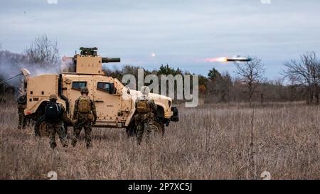 U.S. Marines with Anti-Tank Training Company, 25th Marine Regiment, 4th Marine Division, Marine Forces Reserve fire a Tube-Launched Optically-Tracked Wire-Guided (TOW) weapon system during a live-fire exercise at Fort Chaffee Joint Maneuver Training Center, Arkansas, March 3, 2023. The Marines fired the TOW weapon system from a Joint Light Tactical Vehicle (JLTV), to familiarize themselves with the safety and firing procedures associated with it. The JLTV family of vehicles comes in different variants with multiple mission package configurations, all providing protected, sustained, networked m Stock Photo