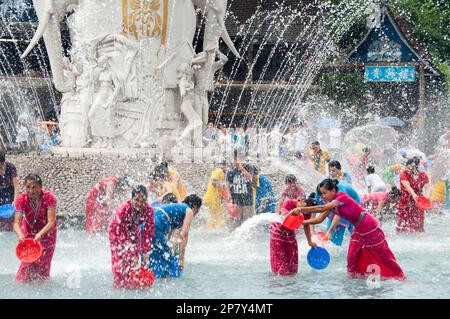 Members of the Dai minority ethnic group celebrate the new years purifying tradition of splashing water on each other at a water park in Yunnan China Stock Photo