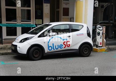 Bras Basah, Singapore - February 18, 2023 - The Blue SG electric car sharing service charging on the station Stock Photo