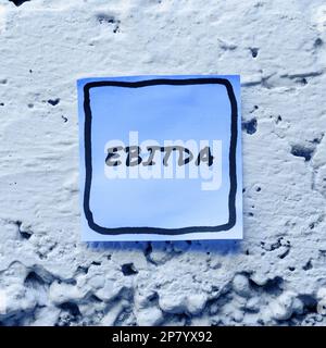Conceptual caption Ebitda. Word Written on Earnings before tax is measured to evaluate company performance Stock Photo
