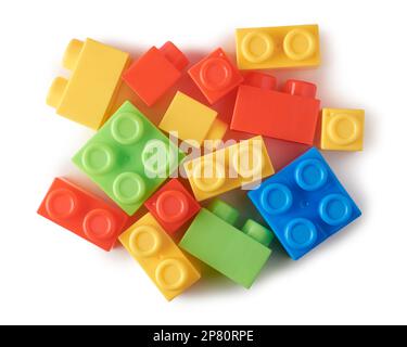 different shapes of toy blocks, aka building blocks, interlocking plastic bricks powerful learning tools baby and kids, scattered on white background Stock Photo