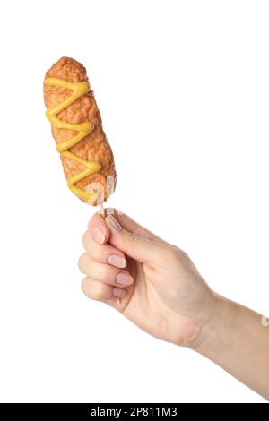 Woman holding delicious deep fried corn dog with mustard on white background, closeup Stock Photo