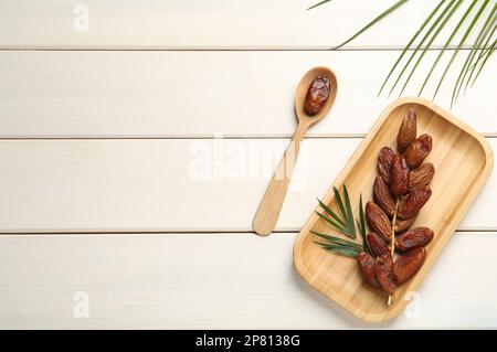 Flat lay composition with tasty sweet dried dates on white wooden table. Space for text Stock Photo