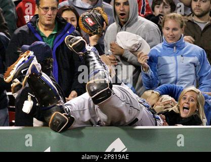 Boston Red Sox's Jason Varitek, right, pats Jed Lowrie, second from right,  after Lowrie's grand slam that brought home Varitek, George Kottaras,  second from left, and Joey Gathright, behind center, in the