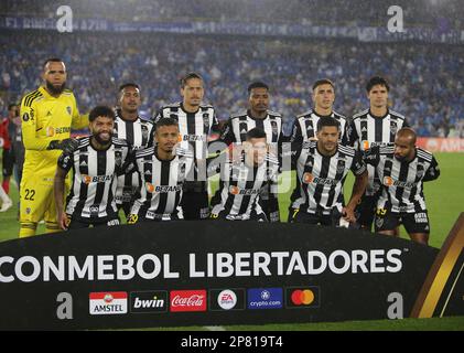 David Silva of Colombia's Millonarios, left, heads to score his side's  opening goal against Brazil's Atletico Mineiro during a Copa Libertadores  soccer match at El Campin stadium in Bogota, Colombia, Wednesday, March