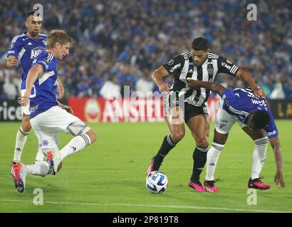 David Silva of Colombia's Millonarios, left, heads to score his side's  opening goal against Brazil's Atletico Mineiro during a Copa Libertadores  soccer match at El Campin stadium in Bogota, Colombia, Wednesday, March