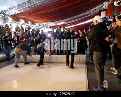 Los Angeles, USA. 08th Mar, 2023. Workers roll out the 'red carpet,' which this year is champagne-colored, on Hollywood Boulevard in front of the Dolby Theatre for the 95th Academy Awards. Credit: Barbara Munker/dpa/Alamy Live News Stock Photo